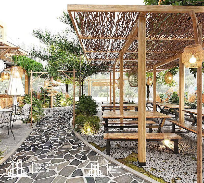 Dự án Cozy Garden do H3 Group thiết kế theo phong cách sân vườn với nền gạch sỏi và hệ thống cây xanh bao phủ