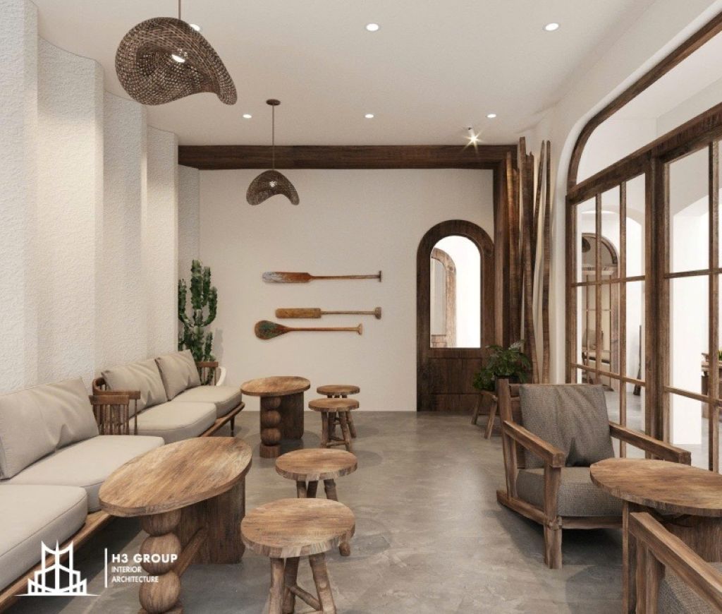 Khu vực ngồi trong thiết kế quán cafe nhỏ phong cách tối giản sử dụng tone màu chủ đạo là trắng và bố trí bàn ghế chất liệu gỗ mộc mạc