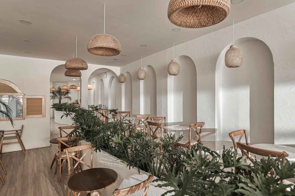 Thiết kế gam màu trung tính kết hợp nội thất gỗ, mây tre mang đến không gian quán cafe phong cách Địa Trung Hải hiện đại, mộc mạc mà thanh lịch