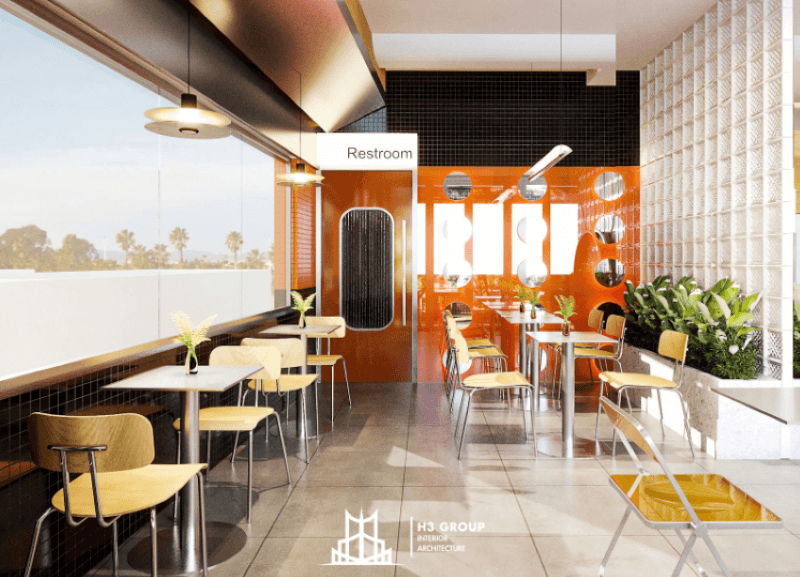 Thiết kế quán cafe nhà ống nổi bật với tông màu cam rực rỡ, sử dụng gạch ốp tường độc đáo cùng ánh sáng tự nhiên, tạo cảm giác năng động và tươi mới.
