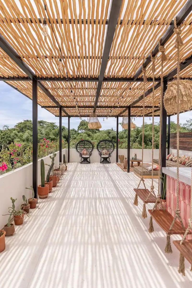 Sân thượng Tropical cafe đón nắng gió tự nhiên, kết hợp cây xanh và nội thất gỗ tạo cảm giác nghỉ dưỡng
