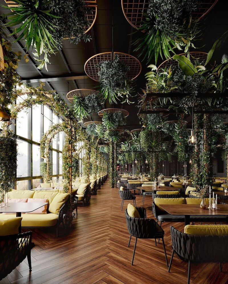 Điểm nhấn chủ đạo của không gian quán cafe Tropical là thảm thực vật, cây xanh phủ kín từ trần nhà xuống sàn, tạo thành những mái vòm lãng mạn và các tầng lớp sống động, mang lại sức sống và sự tươi mát cho toàn bộ không gian