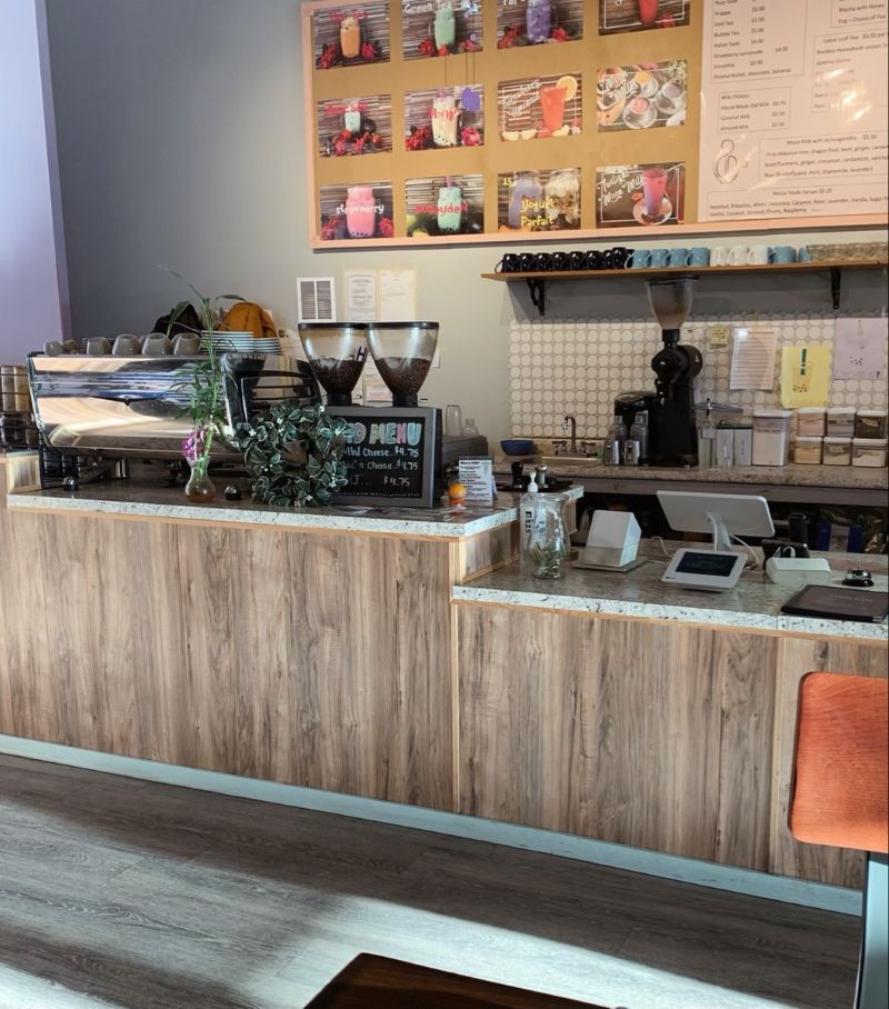 Quầy bar được ốp bằng các tấm gỗ công nghiệp màu nâu nhạt, với vân gỗ rõ nét tạo điểm nhấn, mang đến vẻ đẹp hiện đại, gọn gàng và đầy tính thẩm mỹ  