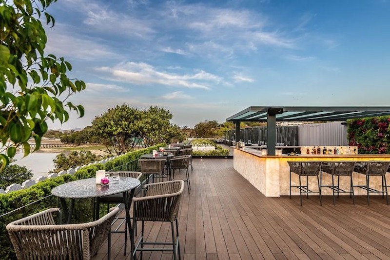 Không gian quầy bar ngoài trời kết hợp bàn cao, ghế cao tạo cảm giác như lounge sang trọng trên nóc nhà.