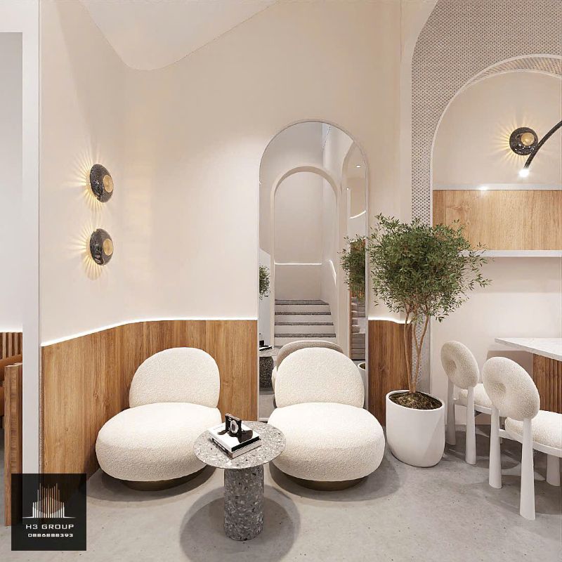 Ghế bọc nỉ màu trắng kem với thiết kế bo tròn, tạo cảm giác êm ái và thân thiện.