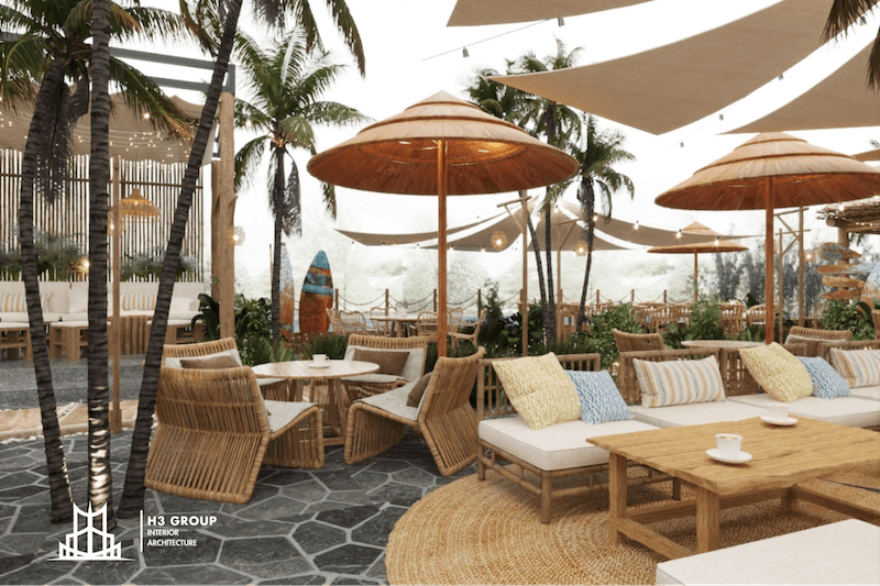 Không gian cafe Tropical với sự hòa quyện giữa ánh sáng tự nhiên, hàng dừa xanh mát và vật liệu tự nhiên tạo nên khung cảnh thư giãn