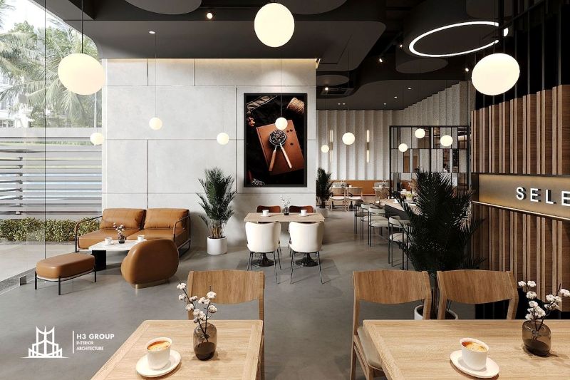 Thiết kế quán cafe trong nhà phong cách hiện đại với không gian thoáng đãng, tối ưu ánh sáng tự nhiên và nội thất tối giản mang lại sự sang trọng