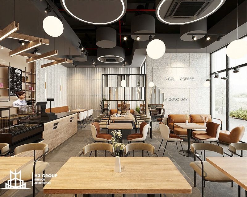 Mẫu thiết kế quán cafe trong nhà hiện đại, với bố trí nội thất  khoa học và quầy bar phía trước, tạo lối đi thoáng và decor tối giản tạo sự thoải mái cho khách hàng