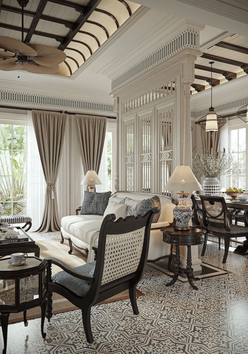 Phòng khách Indochine 80m2 nổi bật với sofa nệm tối màu, bàn gỗ thủ công và đèn lồng trang trí, tạo không gian ấm áp nhưng thanh lịch