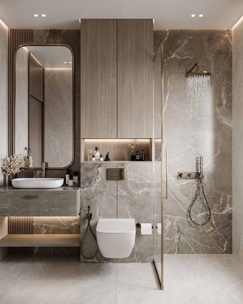 Toilet phong cách Luxury Modern sử dụng gạch Marble, lavabo cao cấp và đèn vàng, tạo không gian vệ sinh sang trọng, tiện nghi và hiện đại