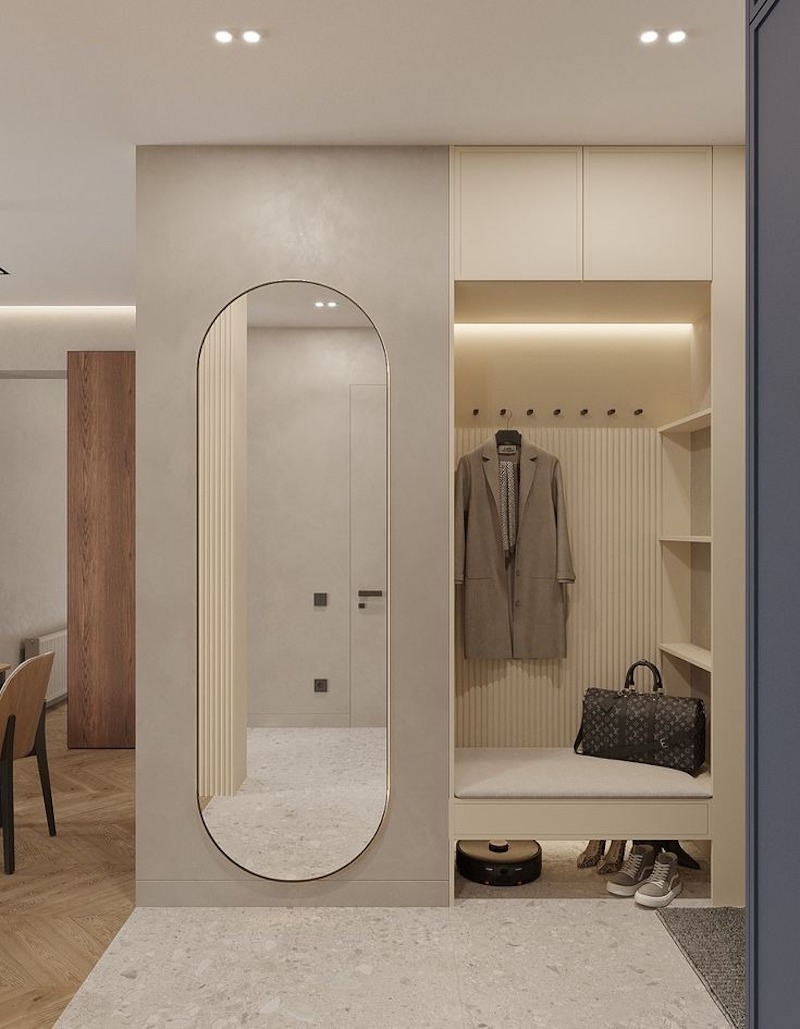 Sảnh vào căn hộ 80m2 rộng rãi, có tủ giày kịch trần, ghế ngồi và gương soi toàn thân, tạo ấn tượng đầu tiên sang trọng, tiện lợi và phân tách không gian rõ ràng 