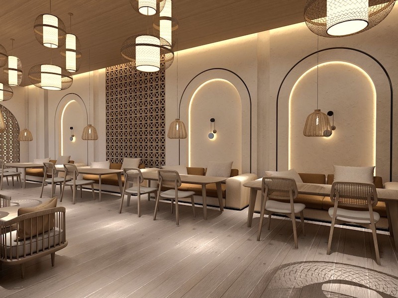 Không gian quán sử dụng tông màu trung tính, bố trí ghế băng dài sát tường, kết hợp hốc vòm và hệ đèn tre tạo cảm giác ấm cúng, thư giãn 