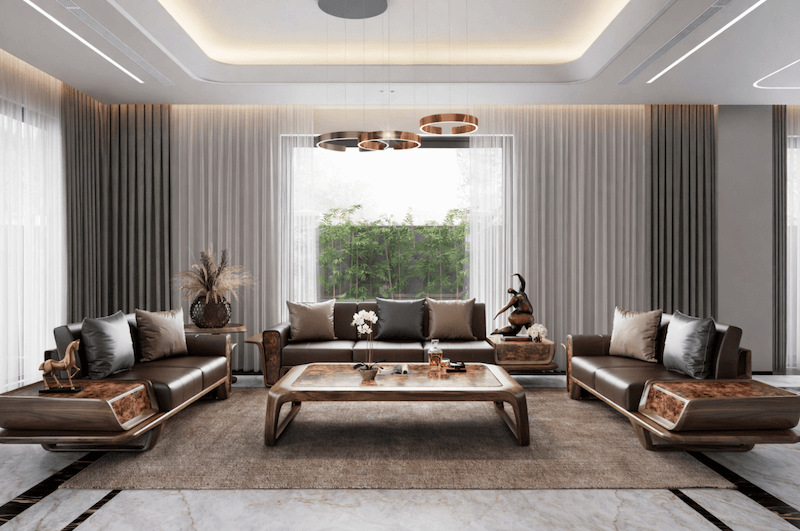 Sofa da tông trầm, bàn trung tâm ốp veneer vân gỗ và hệ rèm hai lớp, kết hợp ánh sáng trần gián tiếp tạo cảm giác sang trọng, ấm áp và thư thái