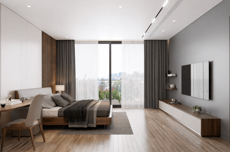 Giường gỗ ấm kết hợp góc làm việc tinh giản và cửa kính lớn mở ban công, tận dụng tối đa ánh sáng tự nhiên và tầm nhìn thoáng đãng