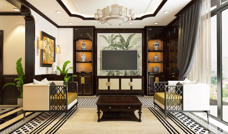 Phòng khách sử dụng bộ sofa khung gỗ uốn lượn, kệ tivi trang trí bình gốm sứ và vách ngăn họa tiết nhiệt đới