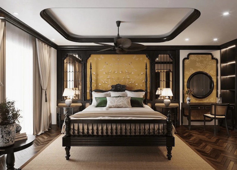 Giường gỗ chạm khắc, vách đầu giường bọc vải họa tiết hoa vàng và sàn gỗ xương cá