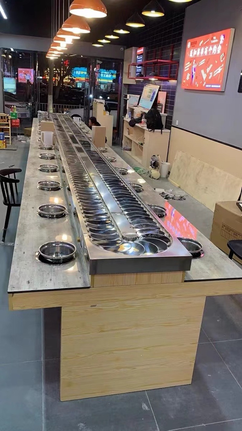 Nhà hàng lẩu băng chuyền để lộ một phần kết cấu và ống dẫn, tạo không gian cá tính, mạnh mẽ nhưng hiện đại 