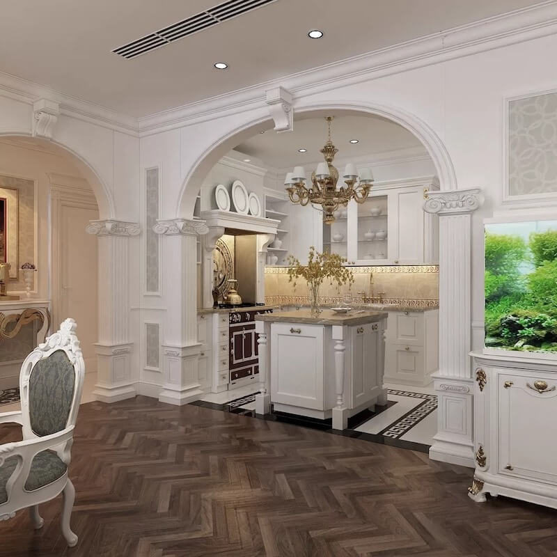 Không gian bếp với vòm cong trang trí và đảo bếp chạm phào tinh tế, kết hợp đèn chùm đồng tạo cảm giác sang trọng, chuẩn mực