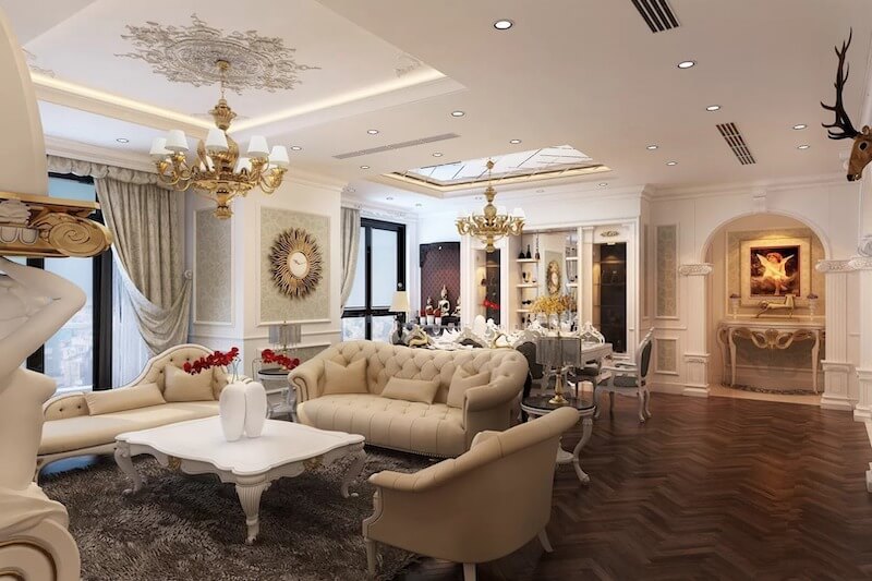 Không gian phòng khách Penthouse Vinhomes Gardenia nổi bật với sofa bọc nệm chần nút mềm mại và đèn chùm mạ vàng cầu kỳ, tạo cảm giác sang trọng, quý phái, ấm áp