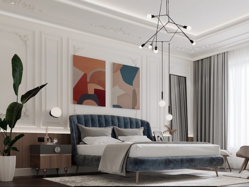 Phào chỉ tinh tế kết hợp nội thất bọc nỉ mềm mại, bảng màu trung tính và ánh sáng hiện đại tạo nên phòng ngủ vợ chồng sang trọng, thư thái