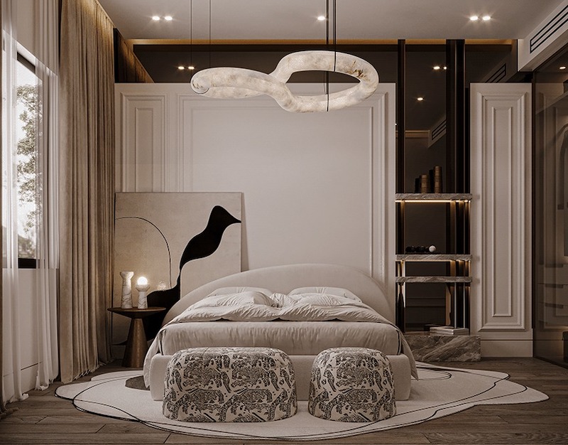 Không gian ngủ dành cho hai vợ chồng với phào chỉ tinh tế, ánh sáng ấm và nội thất bo tròn mềm mại, tạo cảm giác riêng tư, thanh lịch và thư giãn