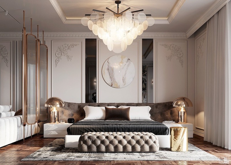 Không gian nghỉ ngơi toát lên vẻ tinh tế với giường bọc nệm capitonné, đèn thả nghệ thuật, phào chỉ trang nhã và bảng màu trung tính, tạo chiều sâu sang trọng