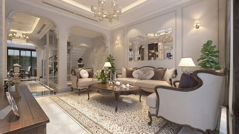 Phòng khách tân cổ điển với gam màu kem nhã nhặn, phào chỉ tinh tế, nội thất bo cong mềm mại và ánh sáng ấm áp tạo cảm giác sang trọng, thanh lịch, gần gũi