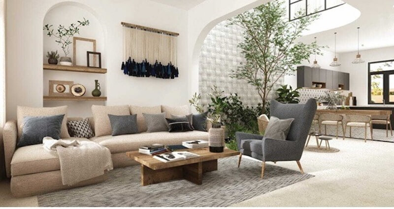 Sofa be trung tính, bàn gỗ mộc, mảng cây xanh và ánh sáng tự nhiên lan tỏa, tạo nên không gian tối giản, ấm cúng, thư thái, gần gũi thiên nhiên