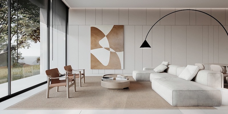 Sofa module thấp tạo cảm giác thư giãn mở rộng, thảm dệt sợi tự nhiên giúp định vị khu sinh hoạt, đèn sàn cong cung cấp ánh sáng tập trung khi đọc sách