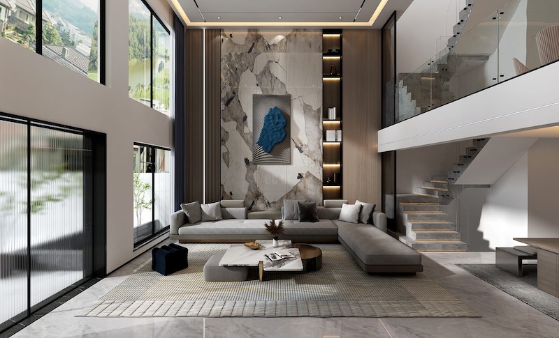 Phòng khách thông tầng gây ấn tượng bởi mảng đá vân lớn làm điểm nhấn, cầu thang kính thanh thoát và bố cục hiện đại, tôn lên chiều sâu không gian