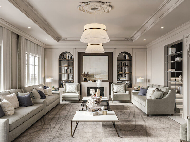 Phòng khách trang nhã với bố cục đối xứng, phào chỉ tinh tế, sofa trung tính, đèn thả hai tầng và kệ âm tường tạo chiều sâu sang trọng, ấm cúng