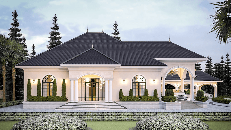 Sân vườn phía trước được chăm chút kỹ lưỡng với thảm cỏ phẳng, bụi cây cắt tỉa hình khối tròn đều và hàng tùng tháp đứng thẳng