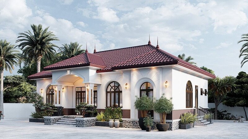 Mặt tiền sử dụng vòm cửa cong, phào chỉ nhẹ và khối tường sơn sáng, mang tinh thần tân cổ điển tinh tế