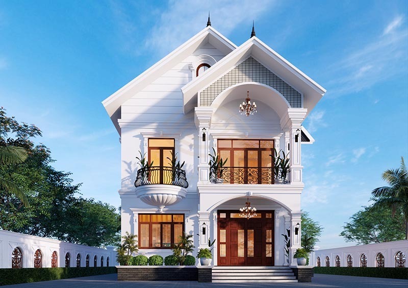 Mặt tiền biệt thự tân cổ điển 2 tầng nổi bật với mái dốc cân xứng, vòm cong mềm mại, cột phào tinh giản, gam trắng thanh lịch và ánh sáng trang nhã