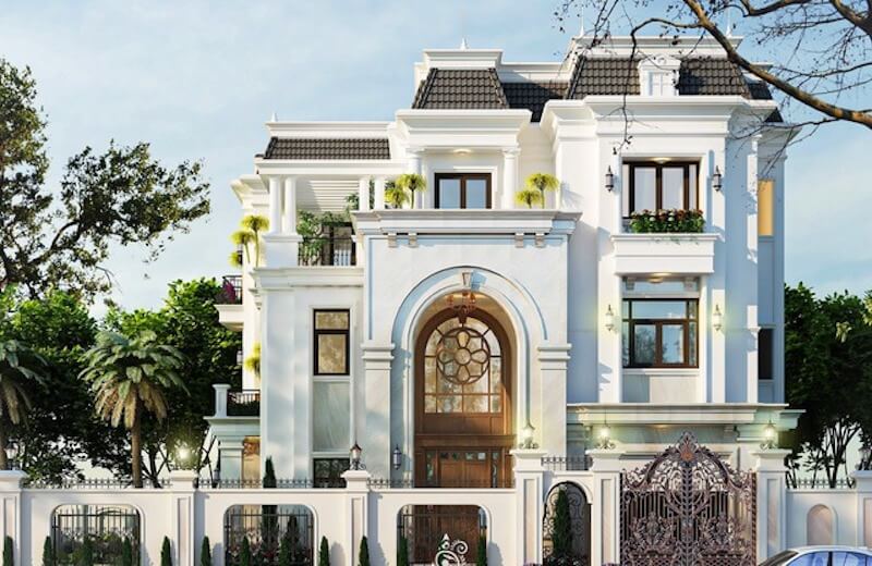 Sảnh vòm lớn ốp đá sáng kết hợp cửa gỗ kính hoa văn tròn tạo điểm nhấn trang trọng, nâng tầm toàn bộ mặt tiền công trình