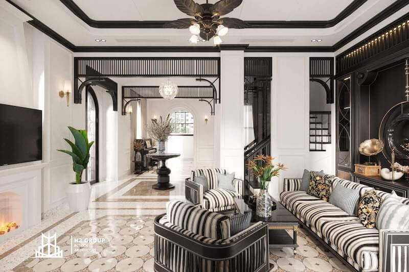 Phòng khách biệt thự phong cách Đông Dương gây ấn tượng với sofa sọc đen trắng, vòm cửa và lam gỗ đặc trưng