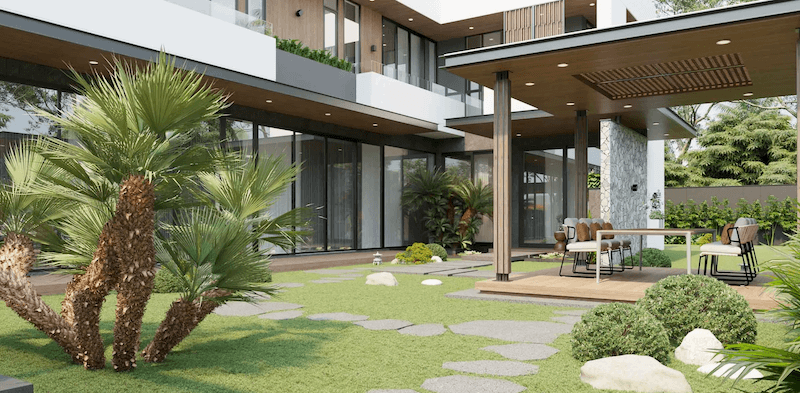 Khoảng sân cỏ rộng kết hợp lối dạo đá phiến uốn mềm dẫn vào khu bàn ăn ngoài trời, trong khi mái hiên ốp gỗ và mảng kính lớn giúp kết nối trọn vẹn giữa nội thất và thiên nhiên 