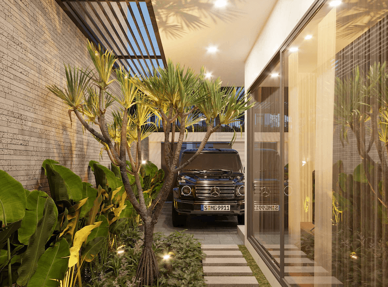 Lối đi nhỏ lát đá xen cỏ xanh dẫn qua tiểu cảnh cây nhiệt đới, tạo không gian sang trọng và gần gũi thiên nhiên