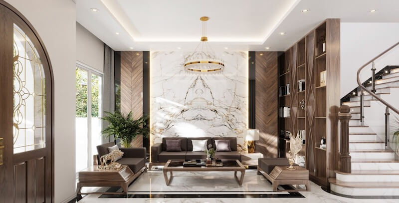 Vách đá marble đối xứng kết hợp hệ ốp và kệ gỗ óc chó tinh tế, đồng thời cửa kính lớn mở ra mảng xanh sân vườn giúp không gian thêm thoáng đãng và giàu sinh khí