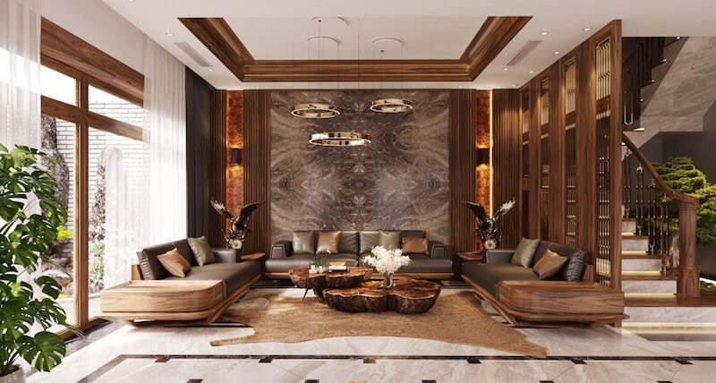 Hệ lam và sofa gỗ óc chó bo cong tinh xảo, đồng thời mảng kính lớn mở ra sân vườn xanh mát giúp tổng thể vừa sang trọng vừa giàu sinh khí tự nhiên