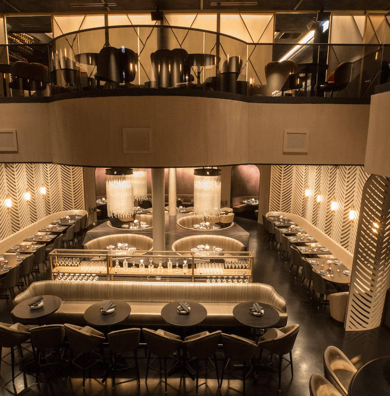 Thiết kế bàn ghế uốn cong, quầy trung tâm và họa tiết tường nghệ thuật giúp không gian trở nên sang trọng, đồng thời tạo điểm nhấn thị giác cuốn hút cho thực khách