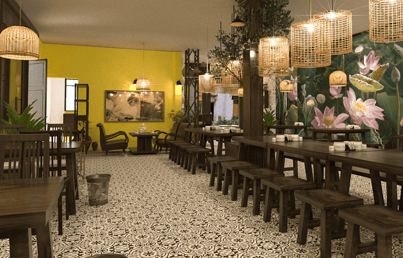 Sàn gạch họa tiết cổ điển kết hợp với tranh tường hoa sen và mảng tường vàng ấm áp giúp không gian vừa mộc mạc vừa giàu nét văn hóa Việt