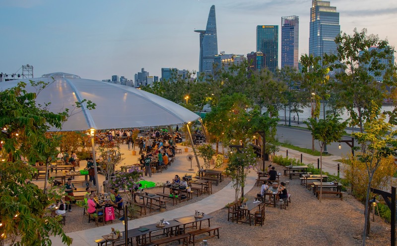 Ánh sáng tự nhiên ban ngày hòa cùng vật liệu gỗ - kim loại tối màu, nhấn mạnh nét mộc mạc, phóng khoáng, phù hợp cho mô hình quán nhậu sân vườn hoặc beer garden