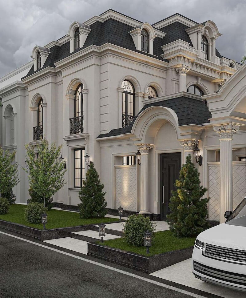 Biệt thự gây ấn tượng với mái Mansard tối màu sang trọng, hệ vòm cong mềm mại kết hợp cột Corinth tinh xảo và ánh đèn hắt tường làm nổi bật từng đường phào chỉ
